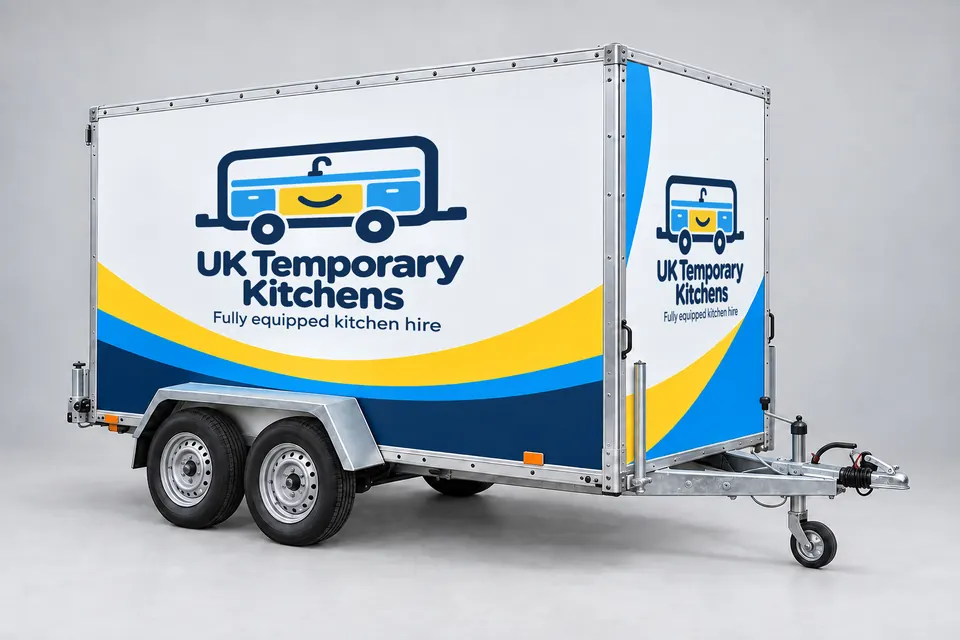 The UK Temporary Kitchens trailer in its white, yellow, blue and navy livery